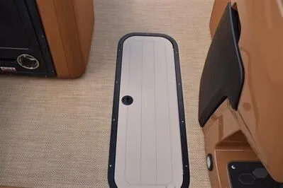 Slide: The Image of 2026 Princecraft Vouge 25 RL boat interior with beige flooring and storage compartment. - 34