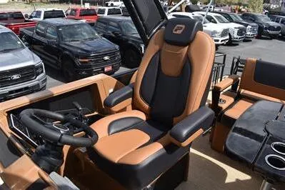 Slide: The Image of 2026 Princecraft Vogue 25 RL boat interior with luxurious captain's chair and steering wheel. - 36