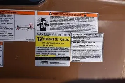 Slide: The Image of Warning and capacity labels on 2026 Princecraft Vouge 25 RL boat, maximum 12 persons or 1725 lbs. - 43