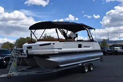 Slide: The Image of 2026 Princecraft Vogue 25 RL pontoon boat on trailer under blue sky. - 44