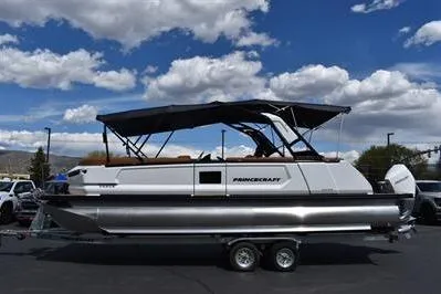 Slide: The Image of 2026 Princecraft Vogue 25 RL pontoon boat with canopy on trailer under blue sky. - 45