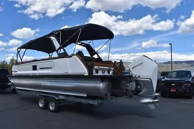 Slide: The Image of 2026 Princecraft Vogue 25 RL pontoon boat on trailer under blue sky. - 46