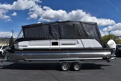 Slide: The Image of 2026 Princecraft Vogue 25 RL pontoon boat with canopy on trailer under blue sky. - 54