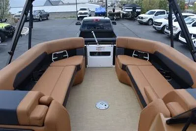 Slide: The Image of 2026 Princecraft Vouge 25 RL pontoon boat with luxurious tan seating and spacious deck. - 9