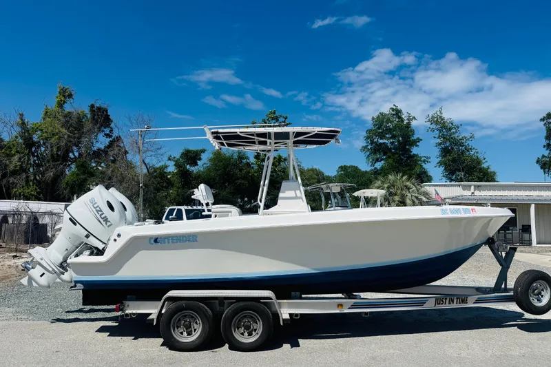 The Image of 1996 Contender 23 CC boat on trailer, Suzuki engines. - 1