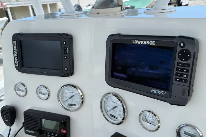 Slide: The Image of Dashboard of a 1996 Contender 23 CC boat with Lowrance electronics and gauges. - 10