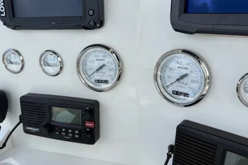 Slide: The Image of Dashboard of a 1996 Contender 23 CC boat with gauges and electronics. - 11