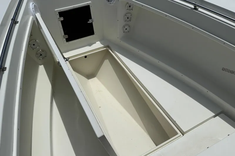 Slide: The Image of Interior view of a 1996 Contender 23 CC boat, showcasing storage compartments. - 13