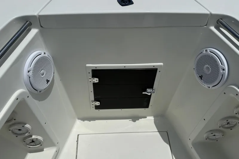 Slide: The Image of 1996 Contender 23 CC boat interior with speakers and storage compartment. - 15