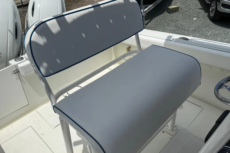Slide: The Image of 1996 Contender 23 CC boat seat with white and blue trim, showcasing cockpit area. - 16