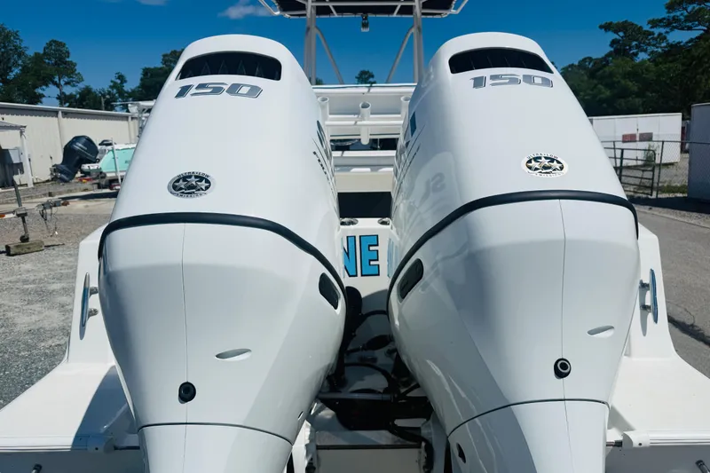 Slide: The Image of Twin 150 horsepower outboard engines on a 1996 Contender 23 CC boat. - 4
