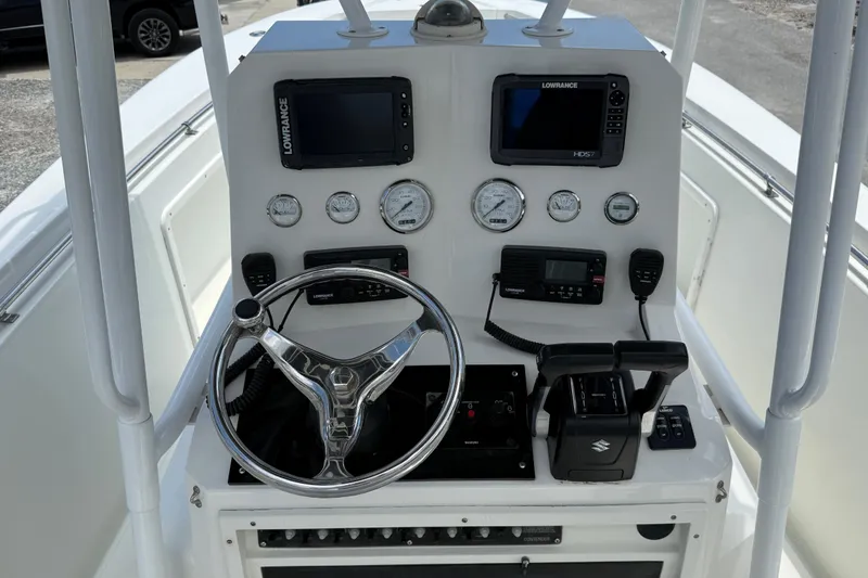 Slide: The Image of Center console of a 1996 Contender 23 CC boat with navigation equipment and controls. - 8
