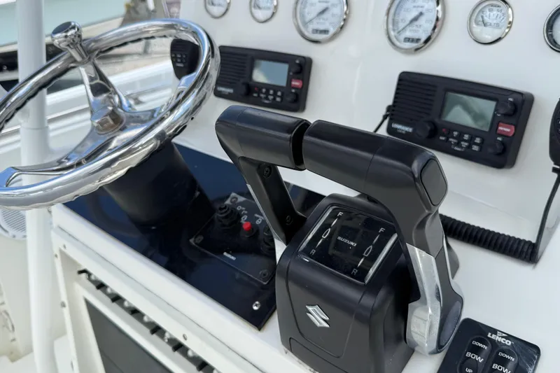 Slide: The Image of Close-up of 1996 Contender 23 CC boat controls, featuring steering wheel and gauges. - 9