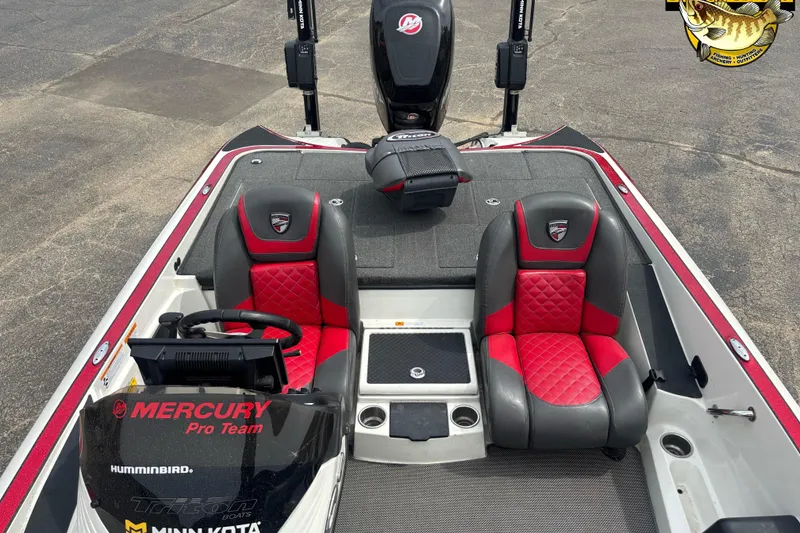 Slide: The Image of 2018 Triton 20 TrX boat interior with red and gray seats, Mercury Pro Team branding. - 5