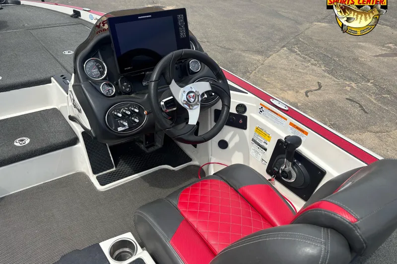Slide: The Image of 2018 Triton 20 TrX boat cockpit with steering wheel, controls, and red-accented seating. - 7