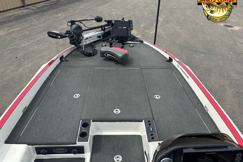 Slide: The Image of 2018 Triton 20 TrX boat deck with fishing equipment and control panel. - 8