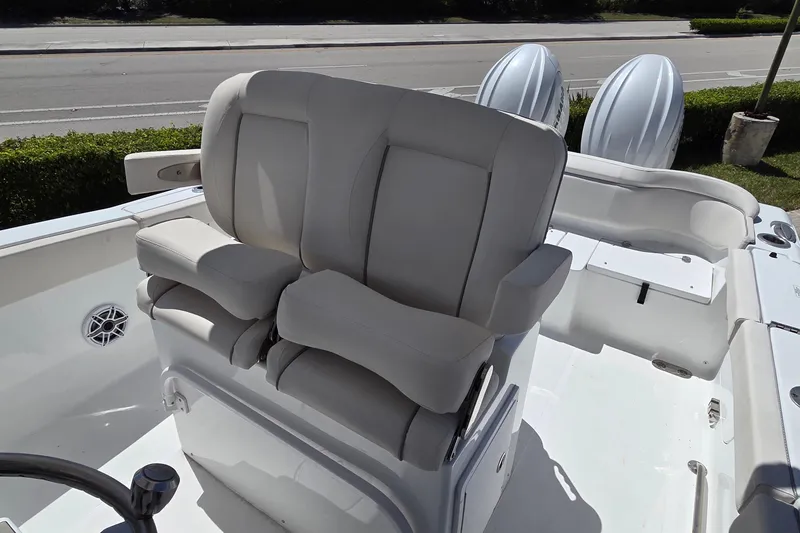 Slide: The Image of 2025 Sea Hunt Ultra 265 SE boat interior with dual cushioned seats and steering wheel. - 10