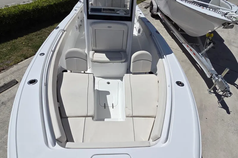 Slide: The Image of 2025 Sea Hunt Ultra 265 SE boat interior with cushioned seating and storage. - 13