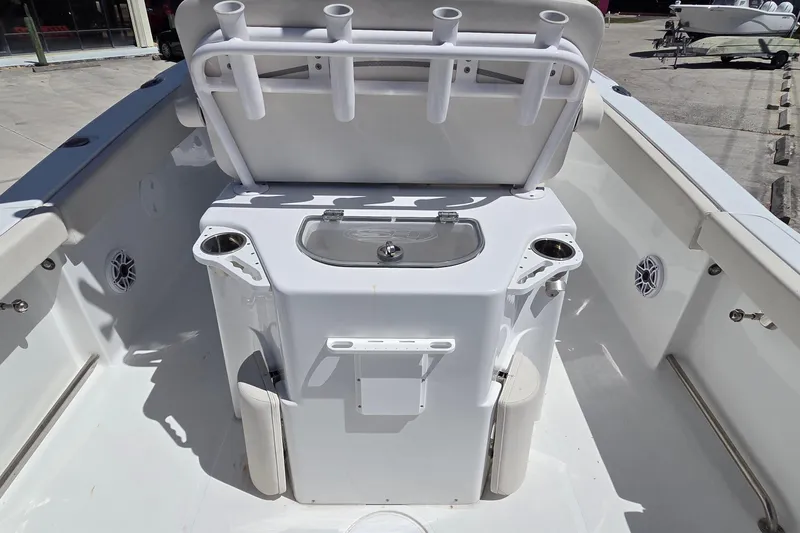 Slide: The Image of 2025 Sea Hunt Ultra 265 SE boat interior with rod holders and storage compartments. - 14