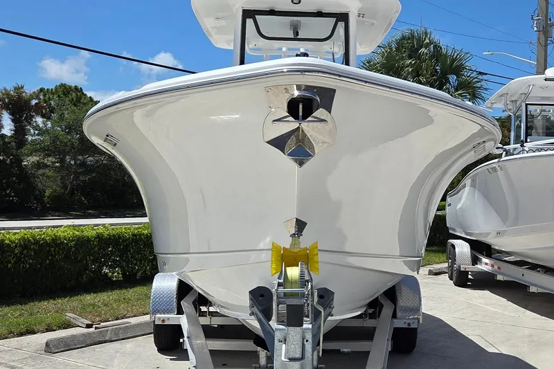 Slide: The Image of 2025 Sea Hunt Ultra 265 SE boat on trailer, front view, sunny day. - 2