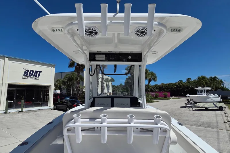 Slide: The Image of 2025 Sea Hunt Ultra 265 SE boat at dealership, featuring rod holders and Garmin electronics. - 4