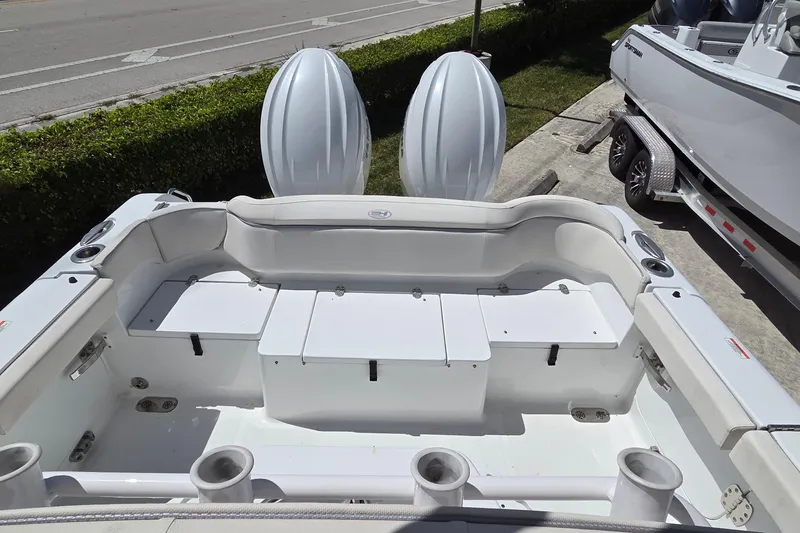Slide: The Image of 2025 Sea Hunt Ultra 265 SE boat with dual engines and spacious seating area. - 5