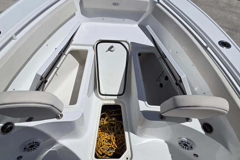 Slide: The Image of Interior view of 2025 Sea Hunt Ultra 265 SE boat, featuring storage compartments and seating. - 7