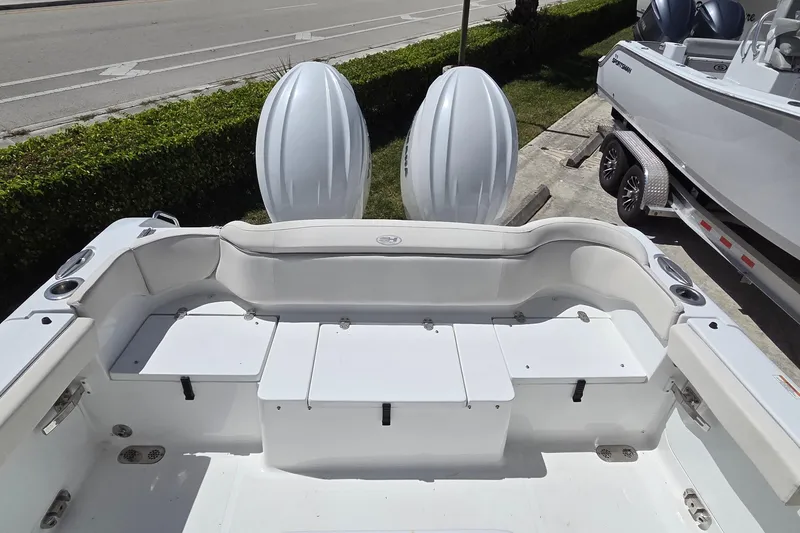 Slide: The Image of 2025 Sea Hunt Ultra 265 SE boat interior with seating and dual engines. - 8
