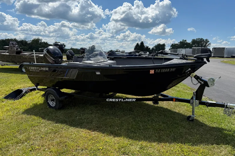 Slide: The Image of 2018 Crestliner 1650 Fish Hawk SC boat on trailer under cloudy sky. - 1