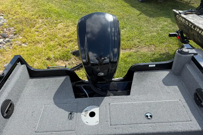 Slide: The Image of 2018 Crestliner 1650 Fish Hawk SC boat with outboard motor, on grassy area. - 6