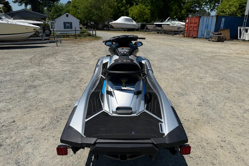 Slide: The Image of 2020 Yamaha WaveRunner FX Cruiser HO parked on gravel lot with boats in background. - 12