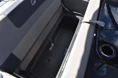 Slide: The Image of 2026 Princecraft Quorum 25 RL boat interior storage compartment with cup holder. - 14