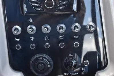 Slide: The Image of Control panel of 2026 Princecraft Quorum 25 RL boat with various switches and buttons. - 24