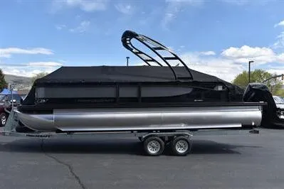 Slide: The Image of 2026 Princecraft Quorum 25 RL pontoon boat with black canopy on trailer. - 28