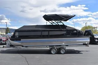 Slide: The Image of 2026 Princecraft Quorum 25 RL pontoon boat with black canopy on trailer. - 35