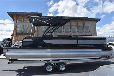 Slide: The Image of 2026 Princecraft Quorum 25 RL pontoon boat on trailer, parked outdoors. - 4