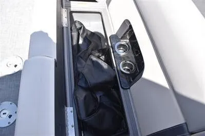 Slide: The Image of 2026 Princecraft Quorum 25 RL boat storage compartment with cup holders and seating. - 8