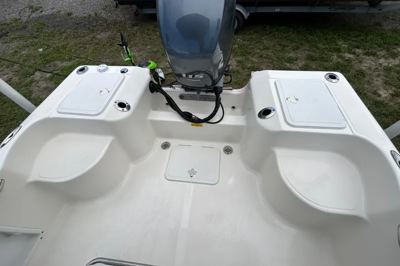 Slide: The Image of 2014 Key West 176 Sportsman CC boat deck with motor and storage compartments. - 10