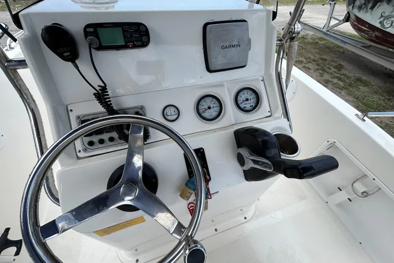Slide: The Image of 2014 Key West 176 Sportsman CC boat dashboard with steering wheel and Garmin device. - 13