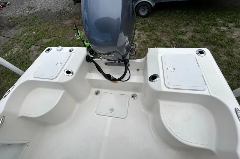 Slide: The Image of 2014 Key West 176 Sportsman CC boat deck with motor and storage compartments. - 14