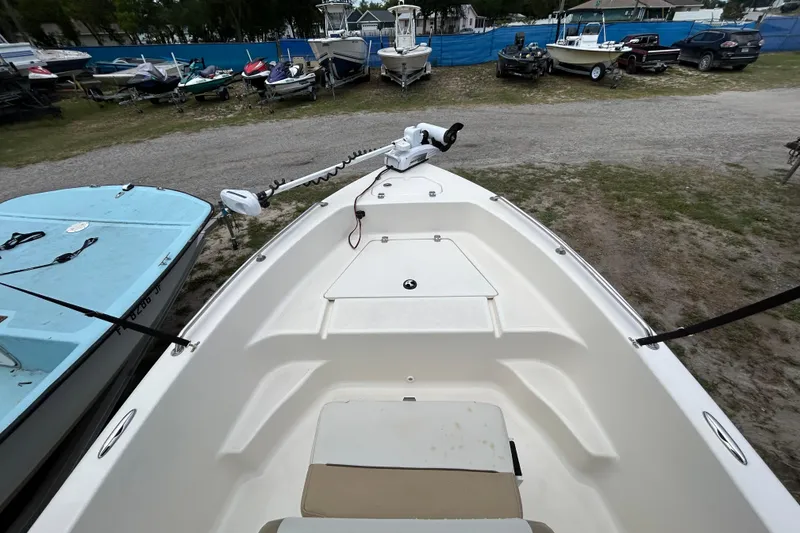 Slide: The Image of 2014 Key West 176 Sportsman CC boat in a marina with other boats. - 18