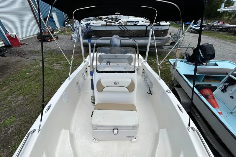 Slide: The Image of 2014 Key West 176 Sportsman CC boat with seating and canopy, parked outdoors. - 7