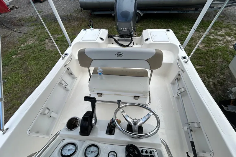 Slide: The Image of 2014 Key West 176 Sportsman CC boat interior with steering wheel and seating. - 9