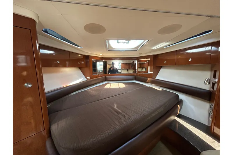 Slide: The Image of Luxurious interior of 2014 Sea Ray Sundancer 350 yacht with spacious bed and elegant wood finish. - 14