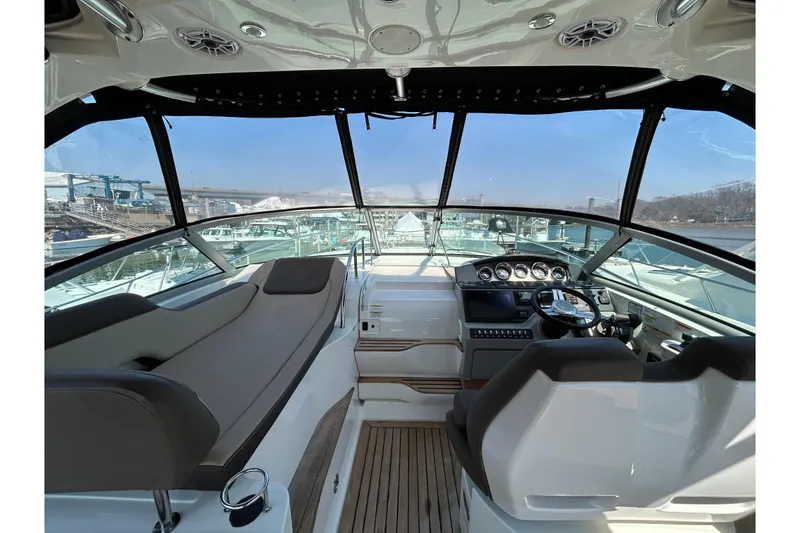Slide: The Image of 2014 Sea Ray Sundancer 350 cockpit with modern controls and panoramic view. - 8