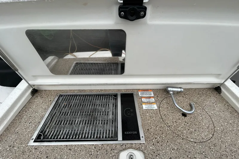 Slide: The Image of 2014 Sea Ray 350 Sundancer boat grill and sink area with Kenyon cooktop. - 2