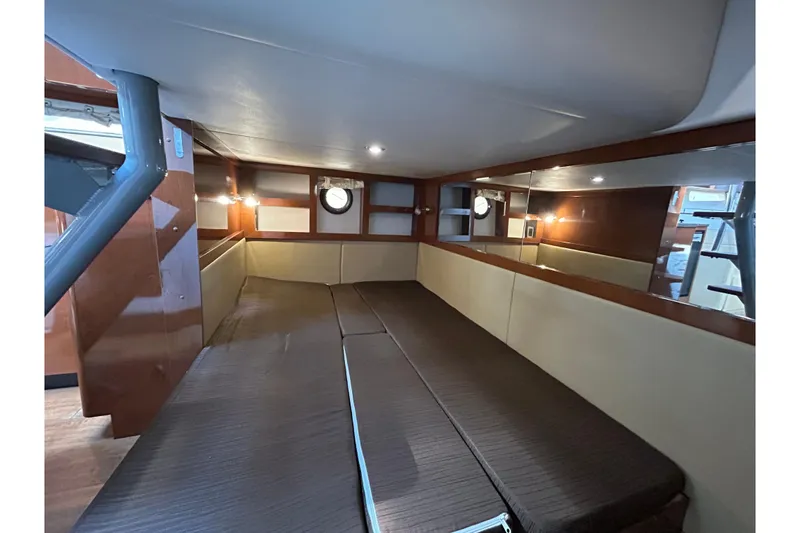 Slide: The Image of 2014 Sea Ray Sundancer 350 cabin interior with cozy seating and ambient lighting. - 15