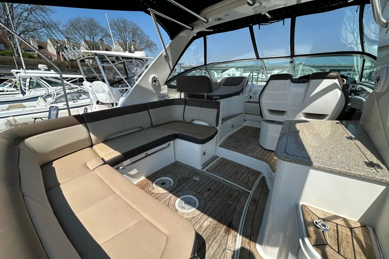 Slide: The Image of 2014 Sea Ray Sundancer 350 interior with spacious seating and elegant design. - 4