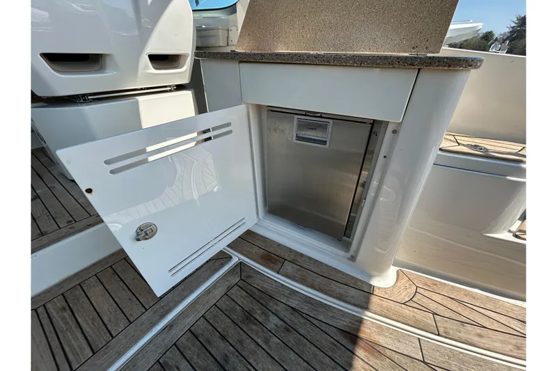 Slide: The Image of Open storage compartment on 2014 Sea Ray Sundancer 350 yacht with wooden deck flooring. - 7