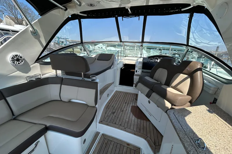 Slide: The Image of 2014 Sea Ray Sundancer 350 interior with plush seating and modern helm. - 5